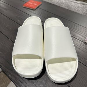 New with out box, never worn Size 11 Nike Calm Slides Sail Color